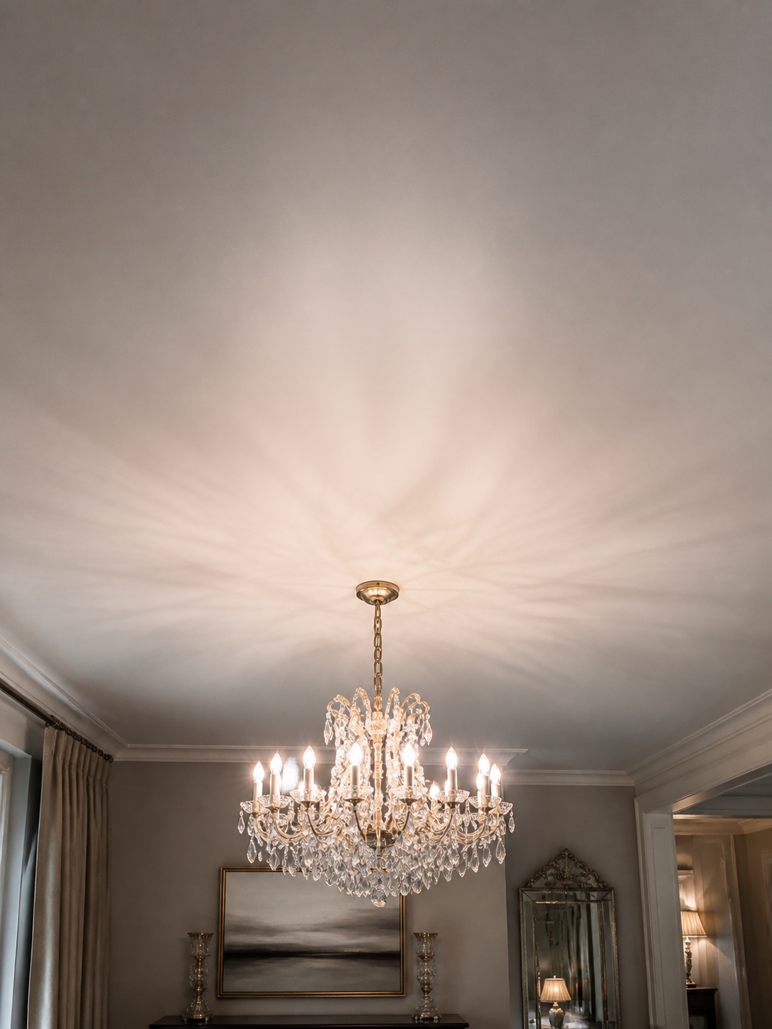 Satin stretch ceiling above a dining room chandelier.