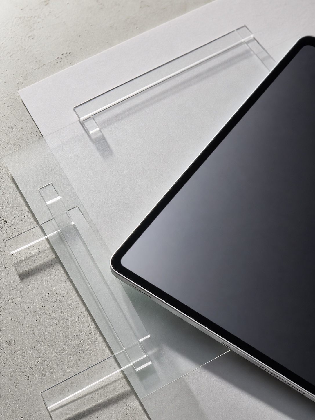 iPad wallpaper aesthetic cover - Adjusting Wallpaper Resolution Tablet with black screen resting on a clear acrylic display stand on a light surface. | Sky Rye Design Aesthetic iPad wallpaper cover for adjusting wallpaper resolution, with a clean modern composition and no text.