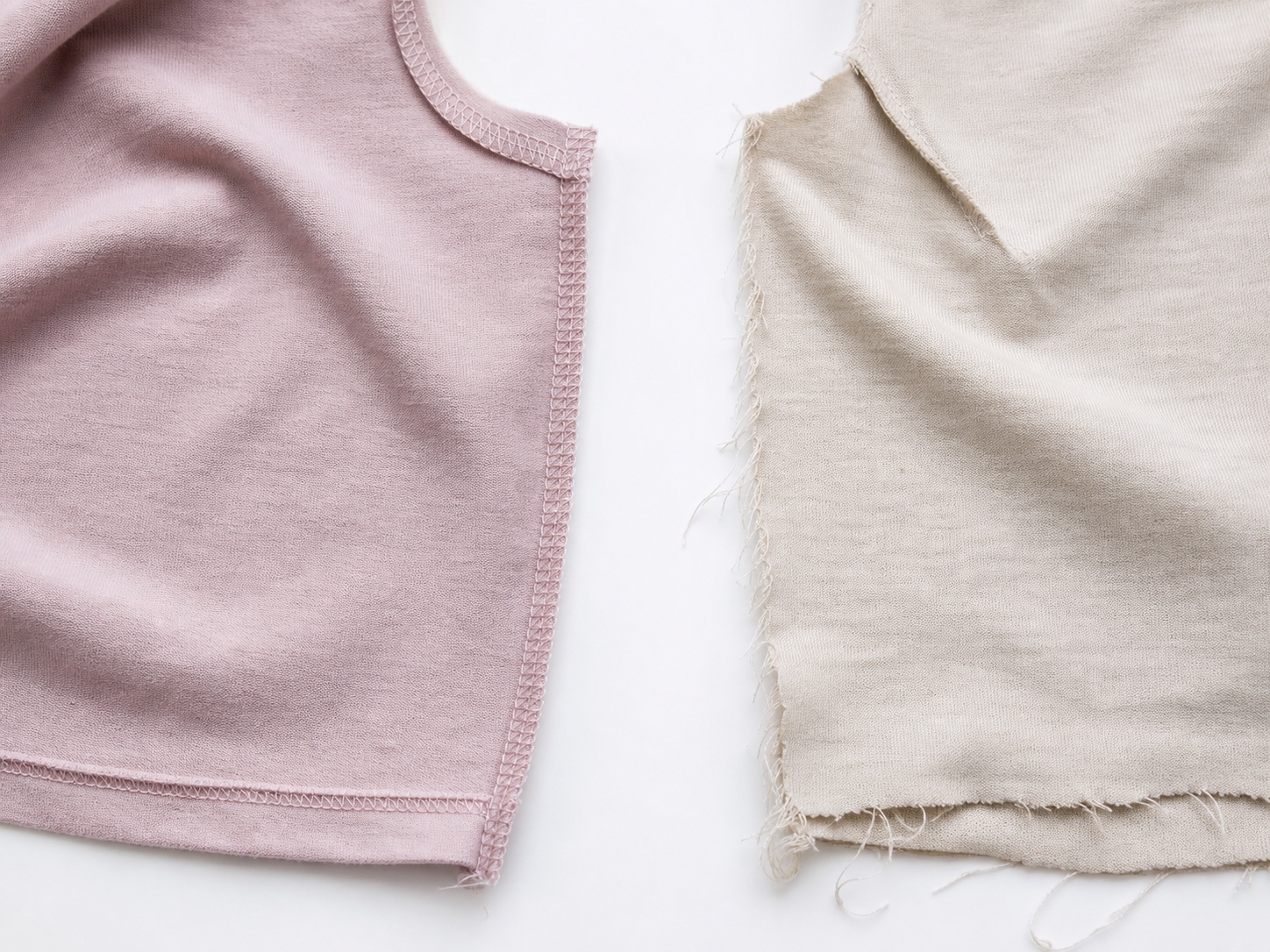 Overhead comparison of garment interiors with clean overlock finishing and raw unfinished edges.