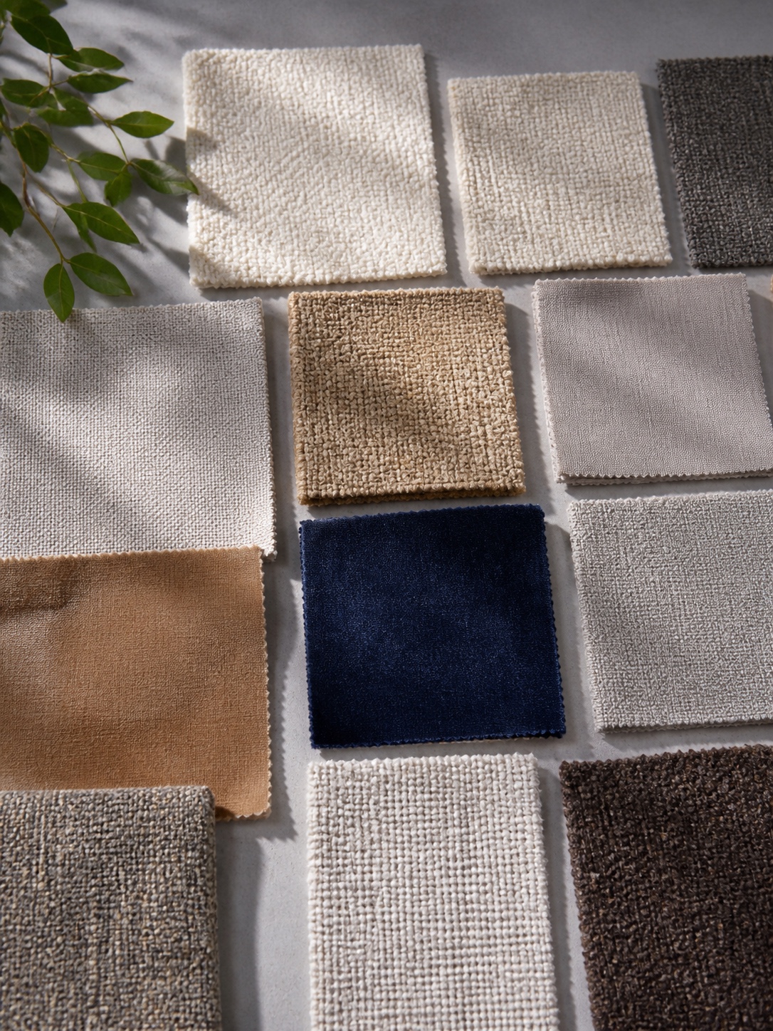 Flat lay of custom sofa fabric swatches in varied textures and colors