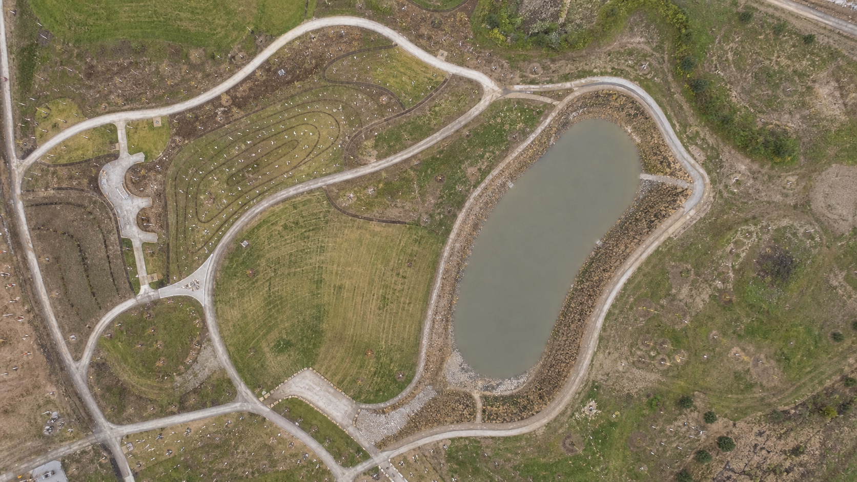 Drone topographic mapping for landscape architecture Top-down drone mapping view of a park landscape architecture site with paths, terrain, and stormwater basin | Sky Rye Design Top-down drone mapping view of a park landscape architecture site with paths, terrain, and stormwater basin