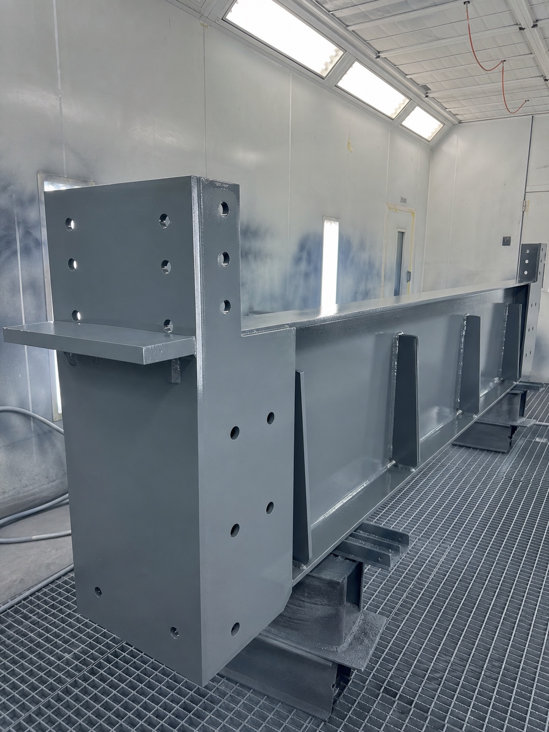 Freshly Coated Structural Steel Assembly Fresh polyurethane topcoat drying evenly on a structural steel assembly in a spray booth. | Sky Rye Design Fresh polyurethane topcoat drying evenly on a structural steel assembly in a spray booth.