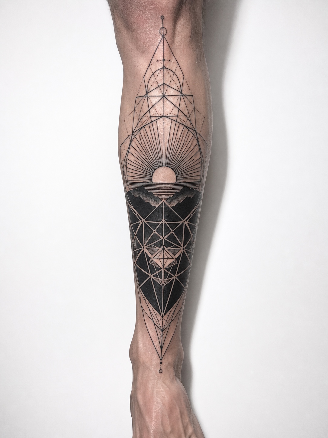 Geometric blackwork sunrise tattoo with polygon lines on the shin.