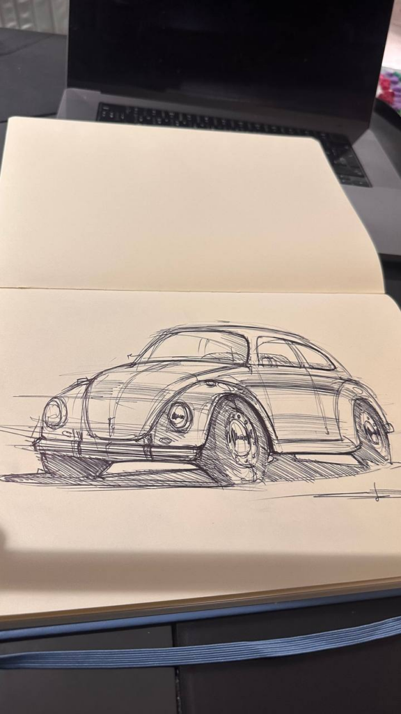 image Ballpoint pen sketch of a classic Beetle-style car in a sketchbook on a laptop, hand-drawn vintage car illustration. | Sky Rye Design Ballpoint pen sketch of a classic Beetle-style car in a sketchbook on a laptop, hand-drawn vintage car illustration.