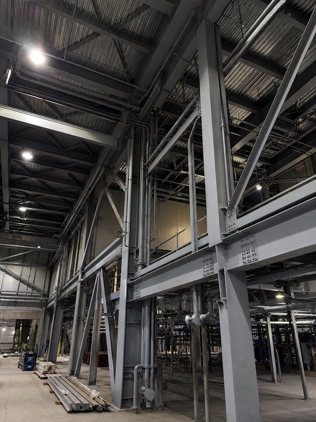 Industrial Facility Exposed Structural Steel Frame Manufacturing facility interior with exposed structural steel protected by an industrial coating system. | Sky Rye Design Manufacturing facility interior with exposed structural steel protected by an industrial coating system.