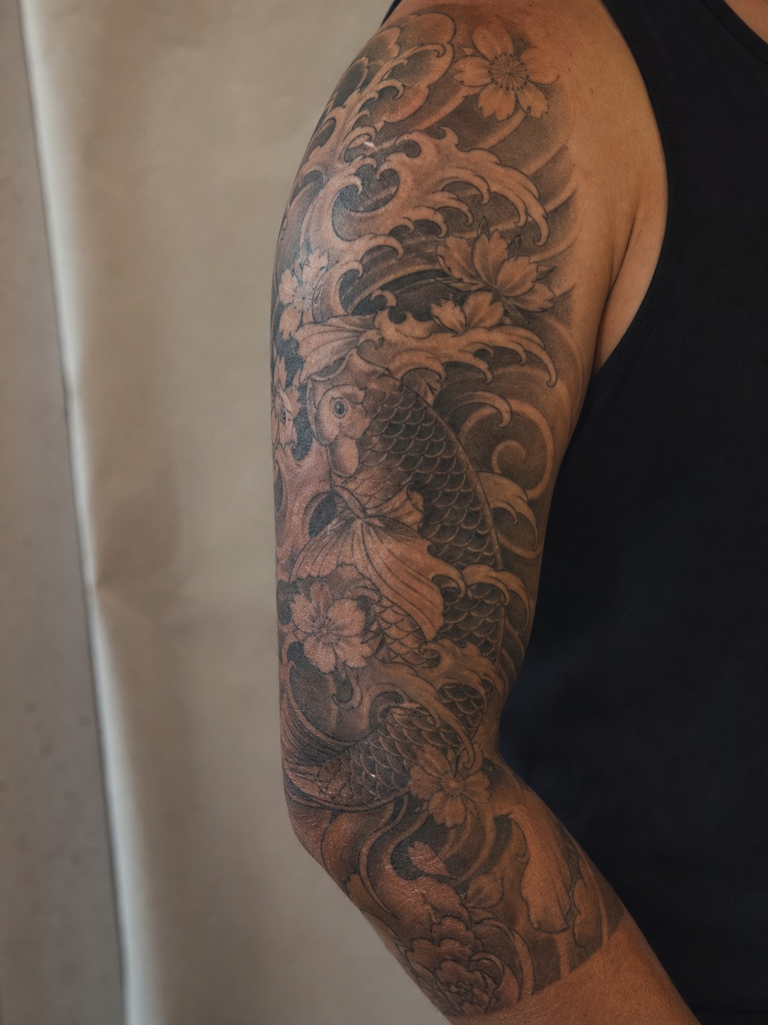 Japanese inspired half sleeve tattoo for men Japanese inspired half sleeve tattoo for men with waves, flowers, and koi movement | Sky Rye Design Japanese inspired half sleeve tattoo for men with waves, flowers, and koi movement