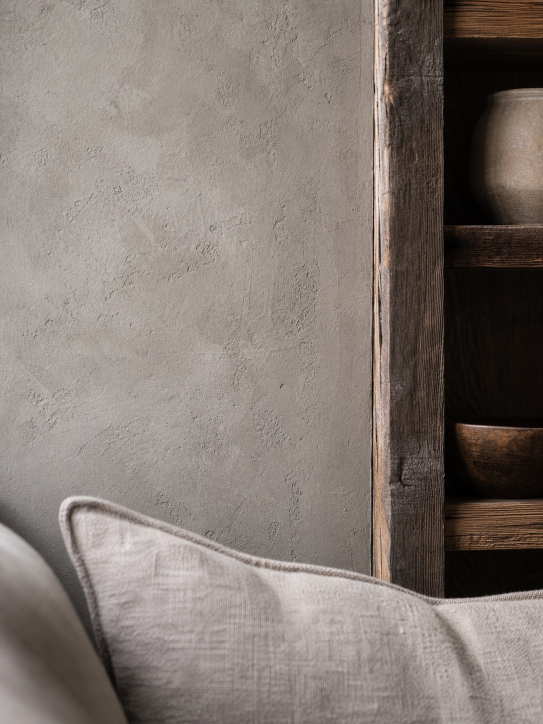 Limewash wall and reclaimed wood interior detail Soft side light reveals a limewash wall beside reclaimed wood and linen textures. | Sky Rye Design Soft side light reveals a limewash wall beside reclaimed wood and linen textures.