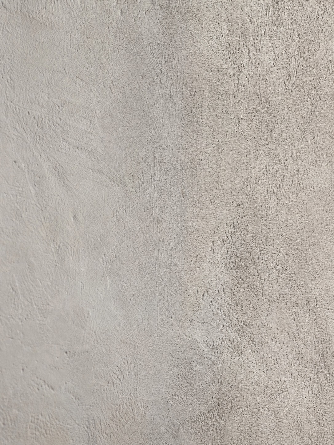 Close-up of limewash wall texture Raking side light shows the soft uneven texture and subtle color variation of limewash paint. | Sky Rye Design Raking side light shows the soft uneven texture and subtle color variation of limewash paint.