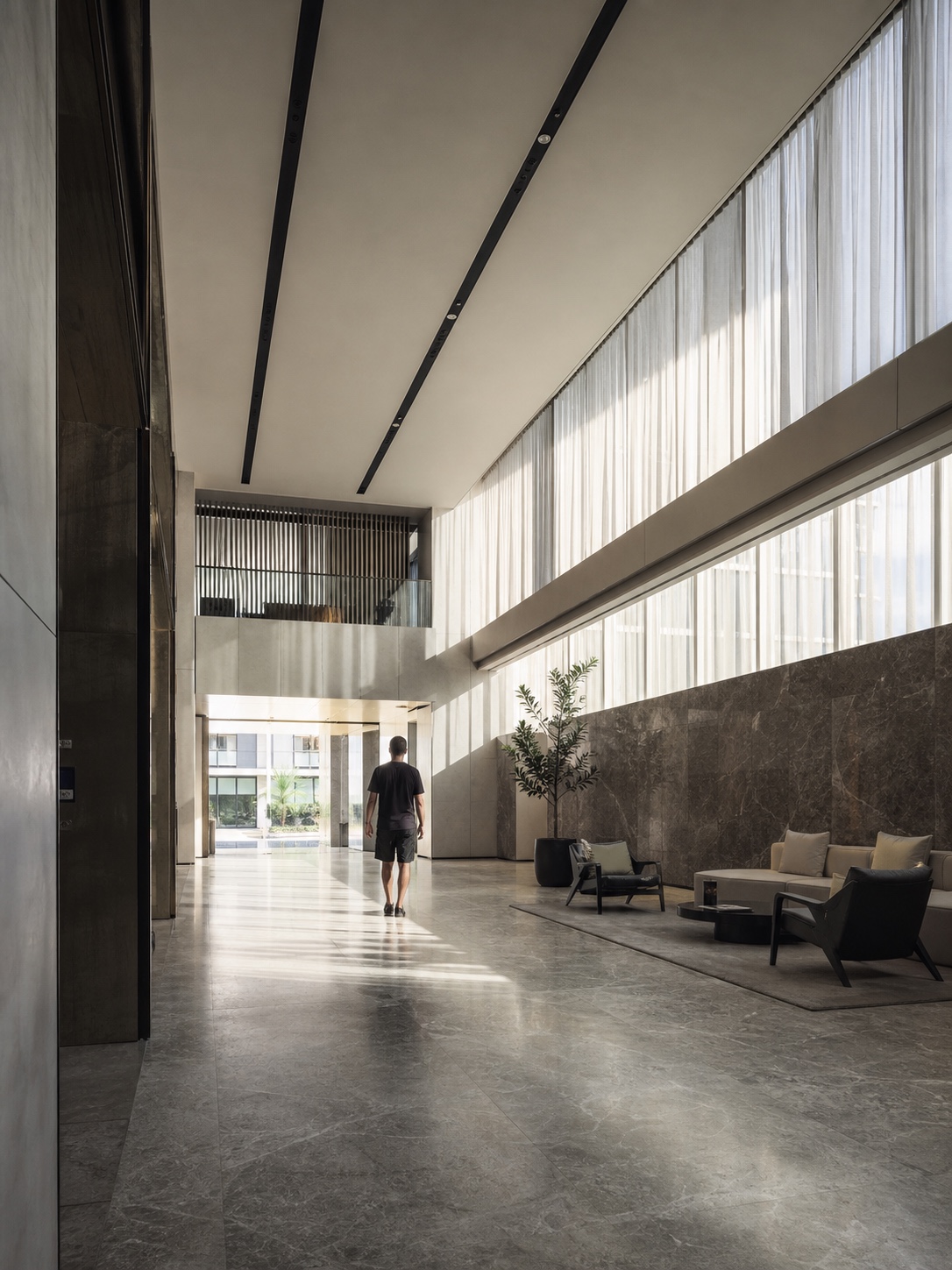 Modern Abu Dhabi residential tower lobby with stone floors and natural light
