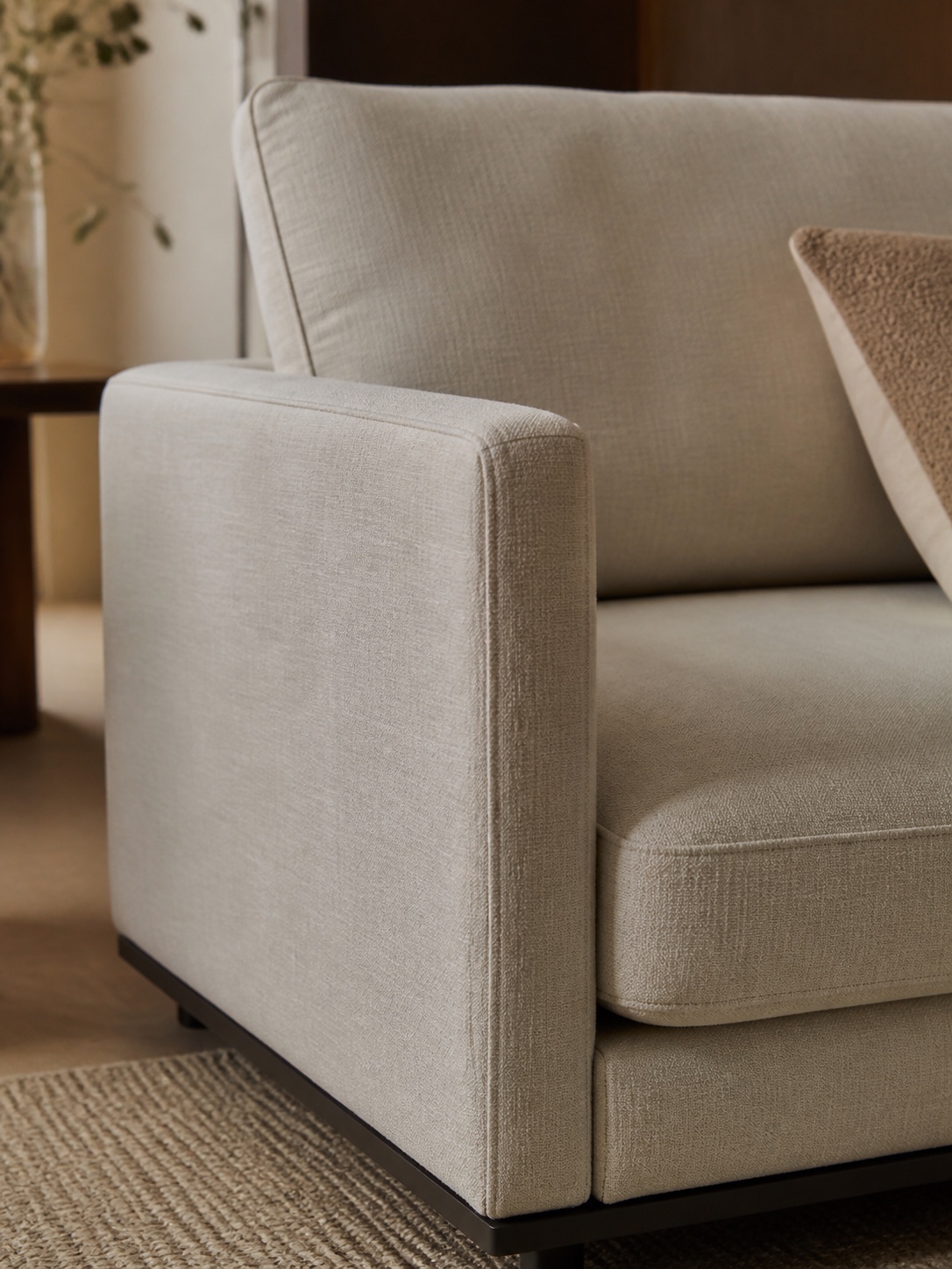 Slim arm track arm modular sofa small room Close view of a slim track arm on a neutral modular sofa. | Sky Rye Design Close view of a slim track arm on a neutral modular sofa.