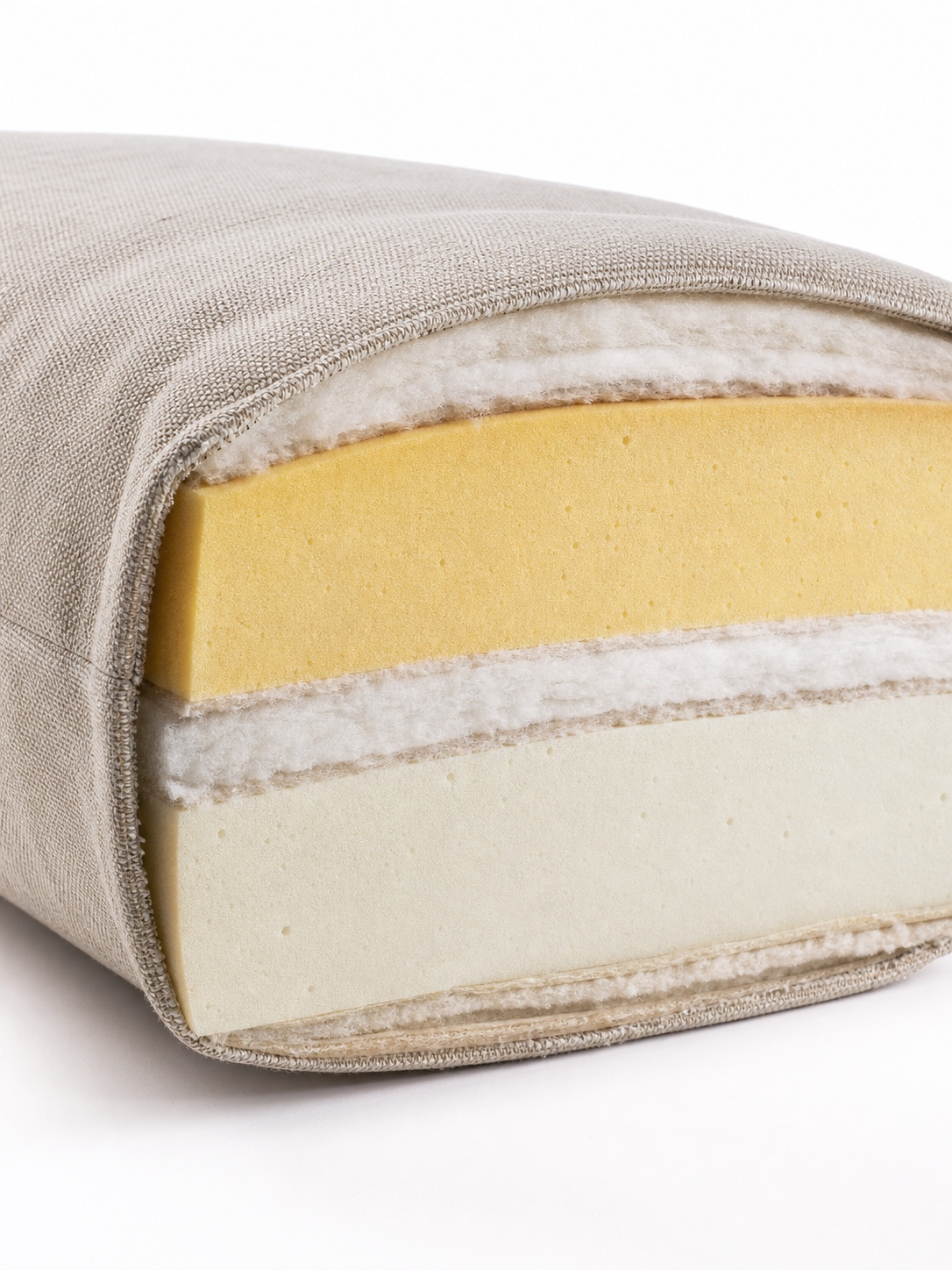 Cutaway sofa cushion showing layered high-density foam and fiber wrap