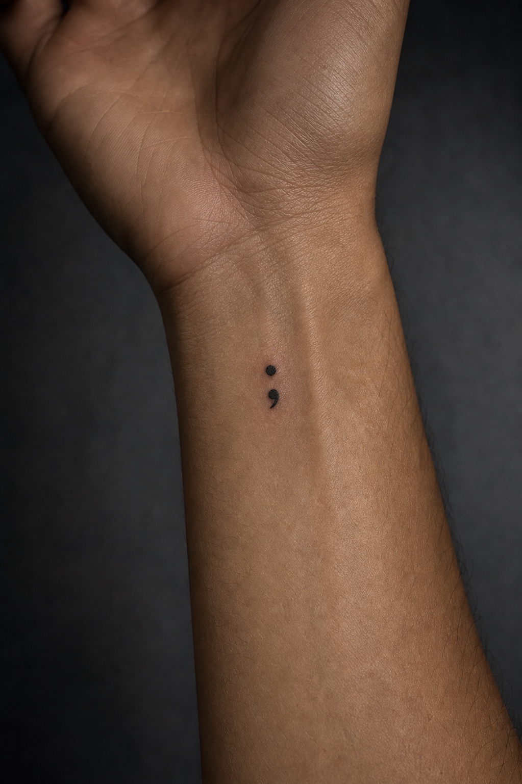 Minimal male semicolon tattoo placement idea