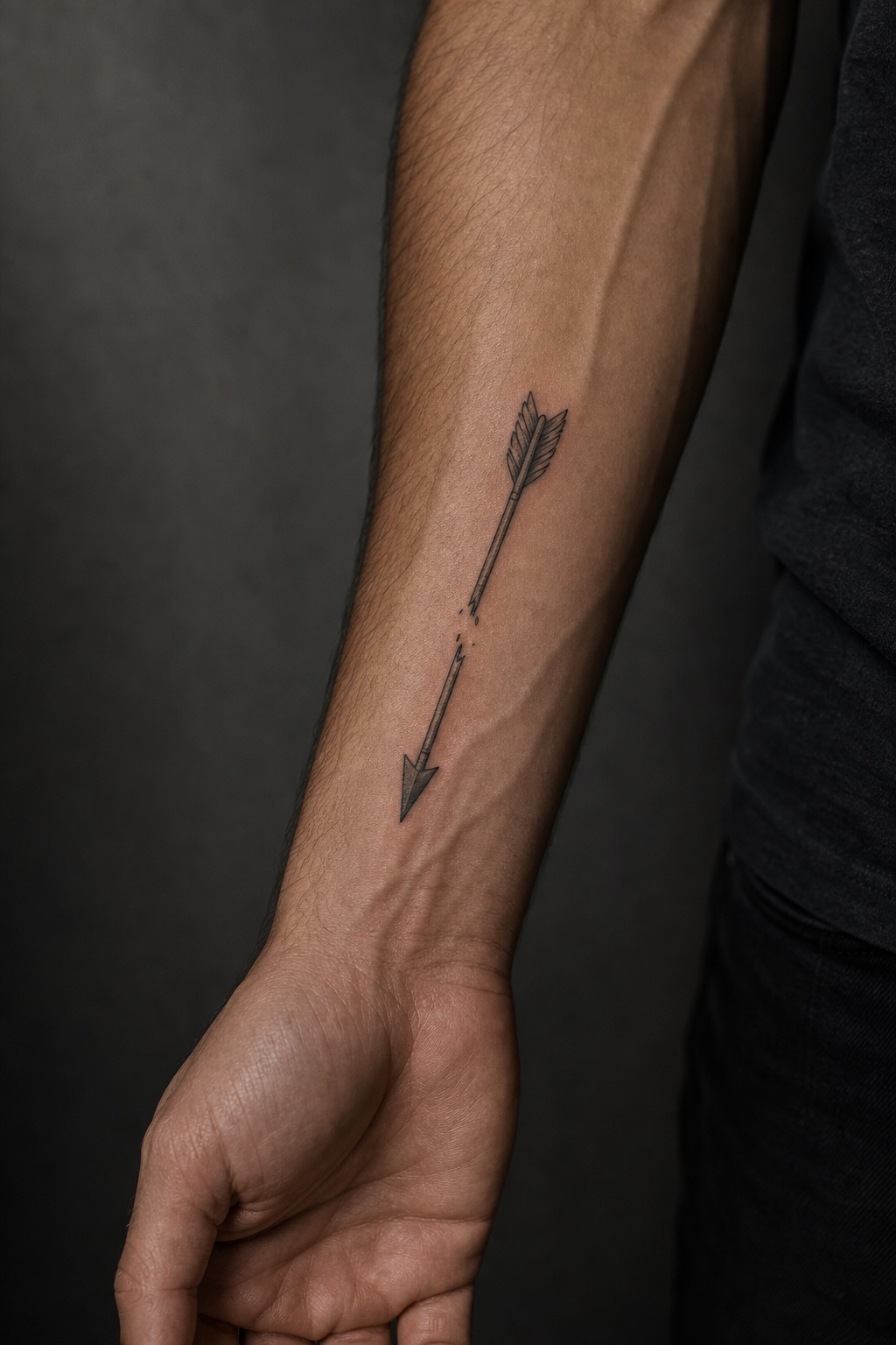 Minimal male broken arrow tattoo placement idea