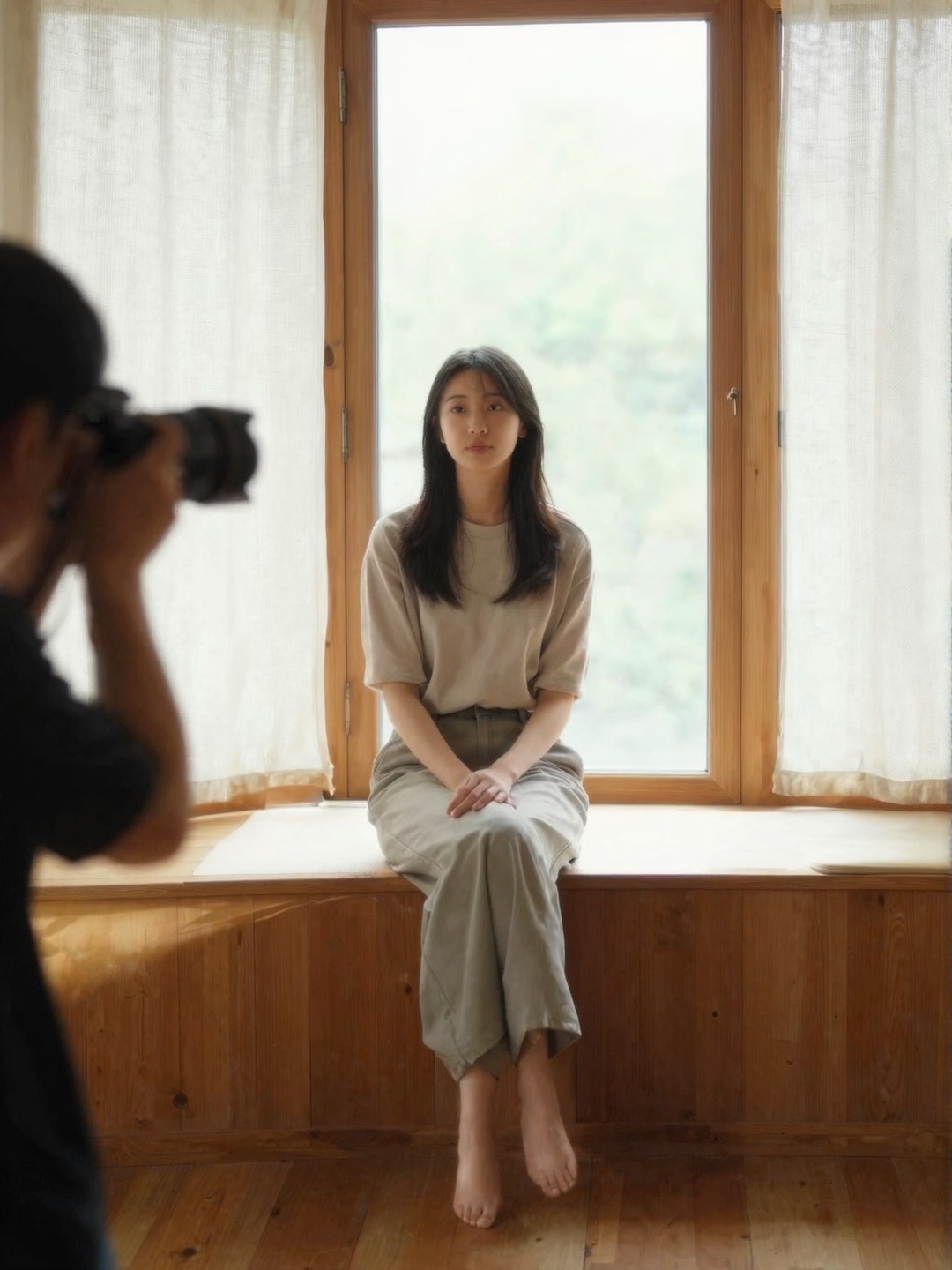 Window Sill Portrait Session Woman sitting on a wooden window sill posing for a photographer in soft natural window light | Sky Rye Design Woman sitting on a wooden window sill posing for a photographer in soft natural window light