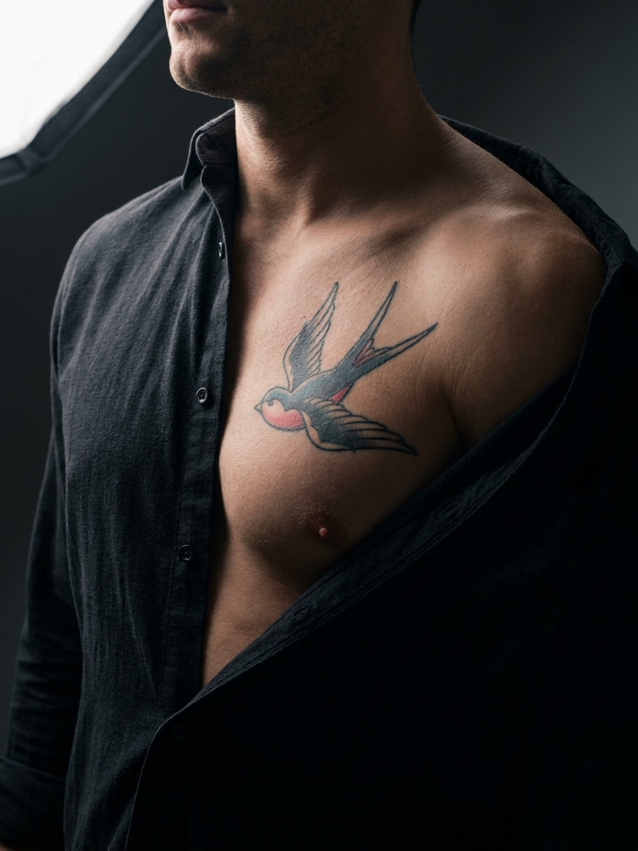 Bold American traditional swallow on a man's chest and pectoral.