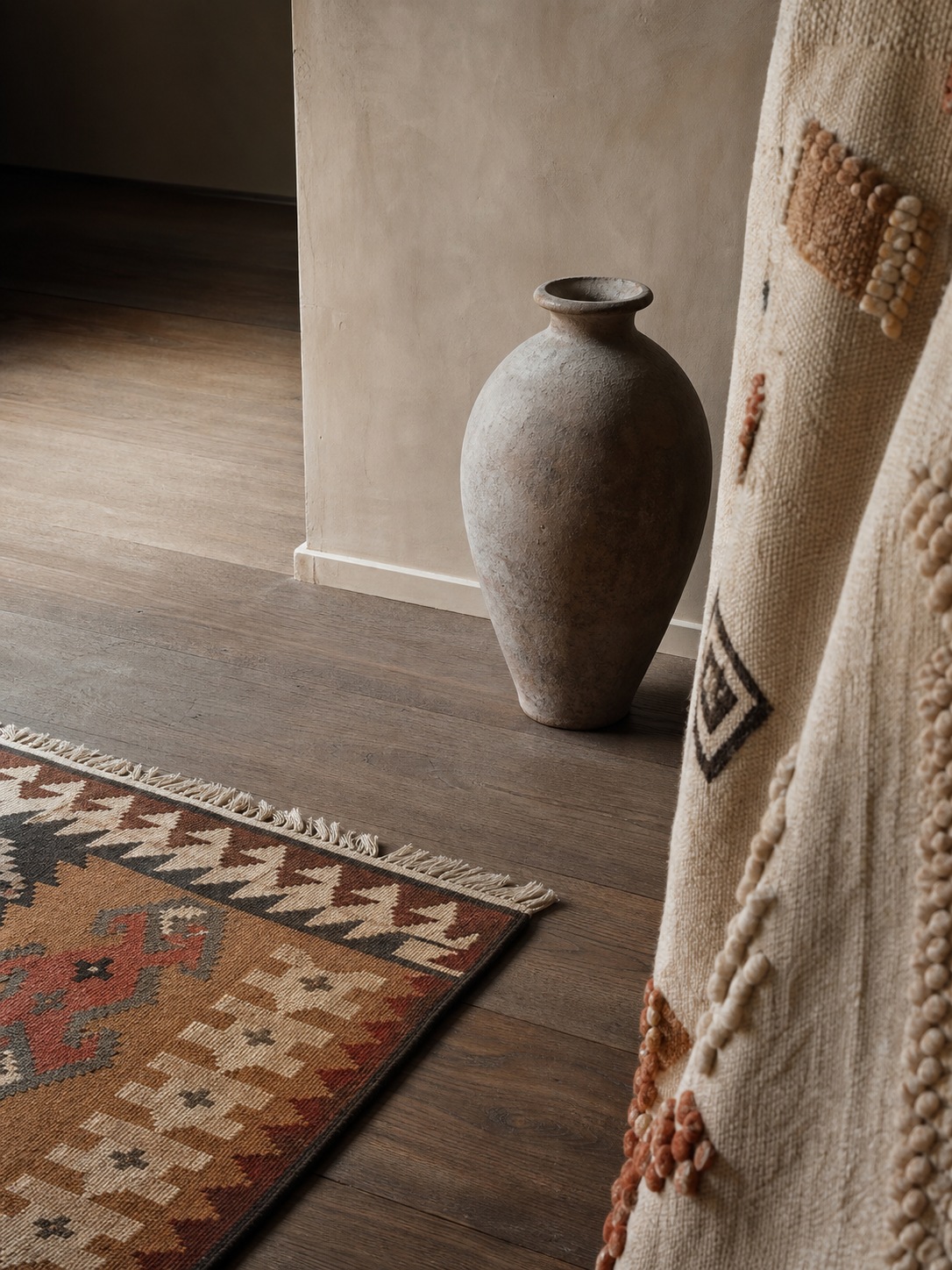 Bohemian texture composition with negative space A close-up composition of a kilim rug, ceramic vessel, and woven textile separated by clear negative space. | Sky Rye Design A close-up composition of a kilim rug, ceramic vessel, and woven textile separated by clear negative space.