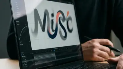 Graphic designer using a stylus on a laptop for colorful Misc logo design, close-up workspace view
