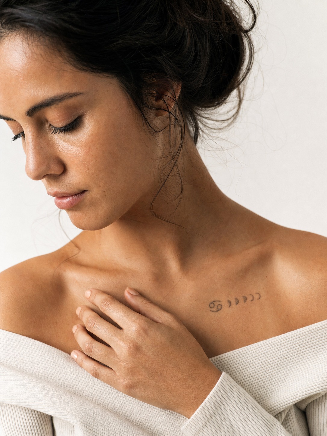 Cancer moon phase chest zodiac tattoo A small Cancer glyph paired with a delicate crescent moon-phase sequence near the collarbone. | Sky Rye Design A small Cancer glyph paired with a delicate crescent moon-phase sequence near the collarbone.
