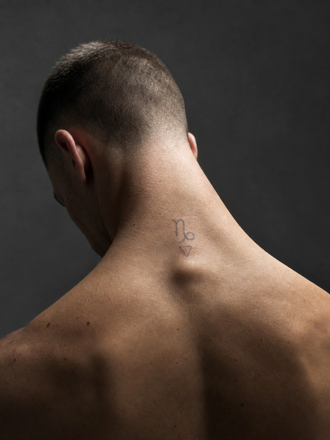 Capricorn geometric neck zodiac tattoo A Capricorn sea-goat glyph with a subtle geometric accent on the back of the neck. | Sky Rye Design A Capricorn sea-goat glyph with a subtle geometric accent on the back of the neck.