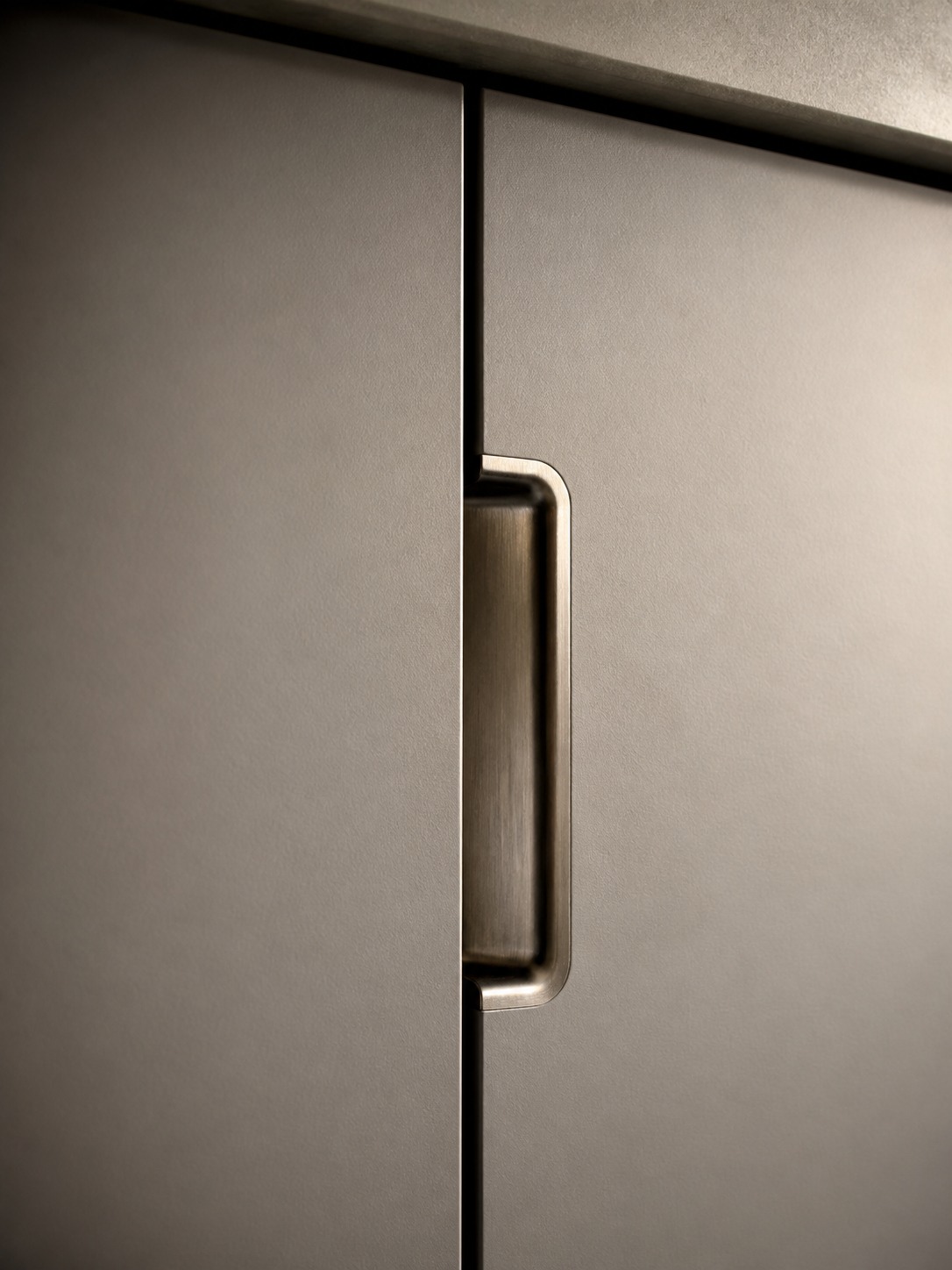 Custom cabinet hardware and precise reveal detail Close detail of discreet integrated cabinet hardware and a precise reveal line between flush panels. | Sky Rye Design Close detail of discreet integrated cabinet hardware and a precise reveal line between flush panels.