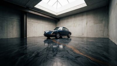 A dark charcoal metallic-swirl epoxy floor in a minimalist architectural garage