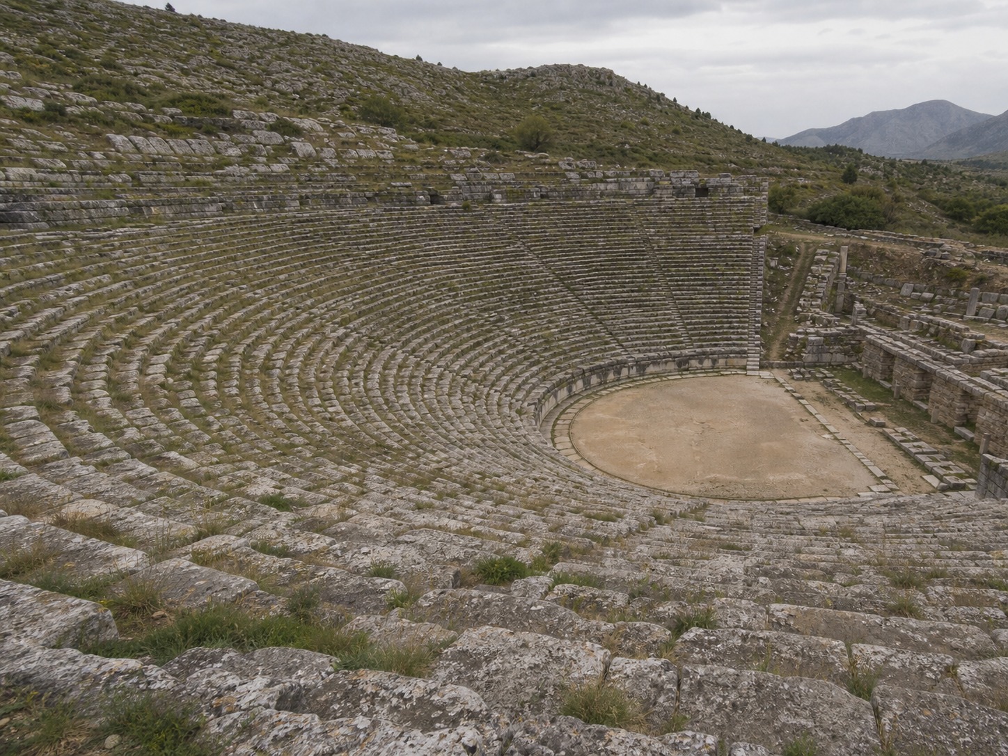 Greek hillside theater stone seating Stone theater seating carved into a hillside with a circular stage at the bottom | Sky Rye Design Stone theater seating carved into a hillside with a circular stage at the bottom