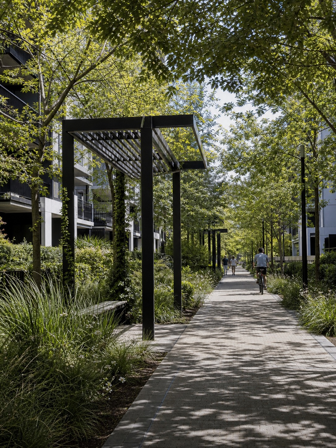 Linear green corridor with a shaded walking and cycling path between residential blocks.