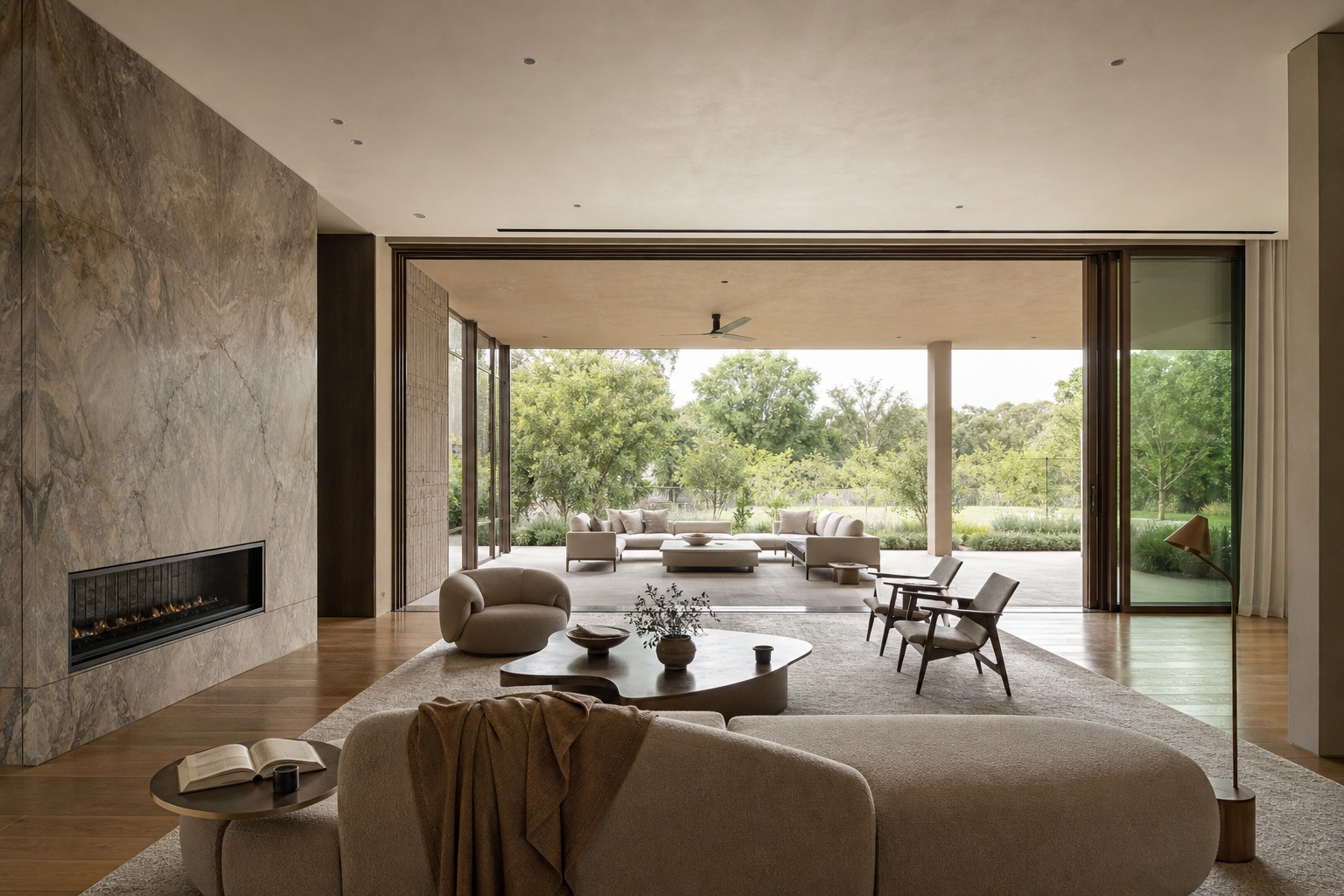 Great room open plan and indoor-outdoor connection Modern great room with a fully open glass wall connecting to a covered rear terrace. | Sky Rye Design Modern great room with a fully open glass wall connecting to a covered rear terrace.