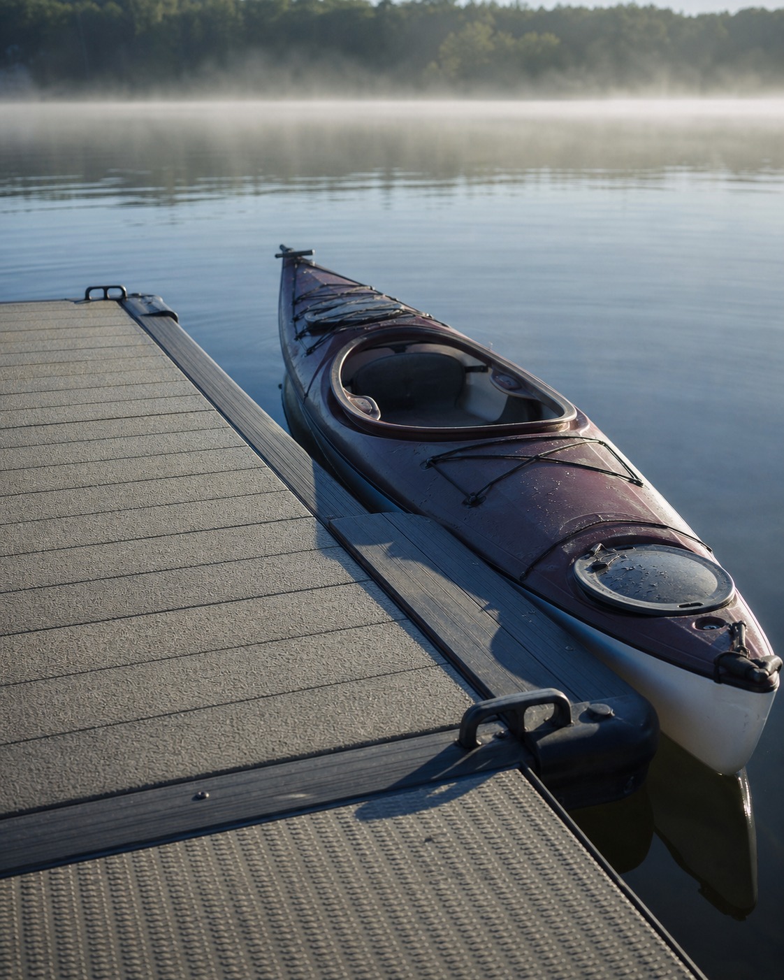 Kayak resting beside a low launch zone built into a floating platform edge.