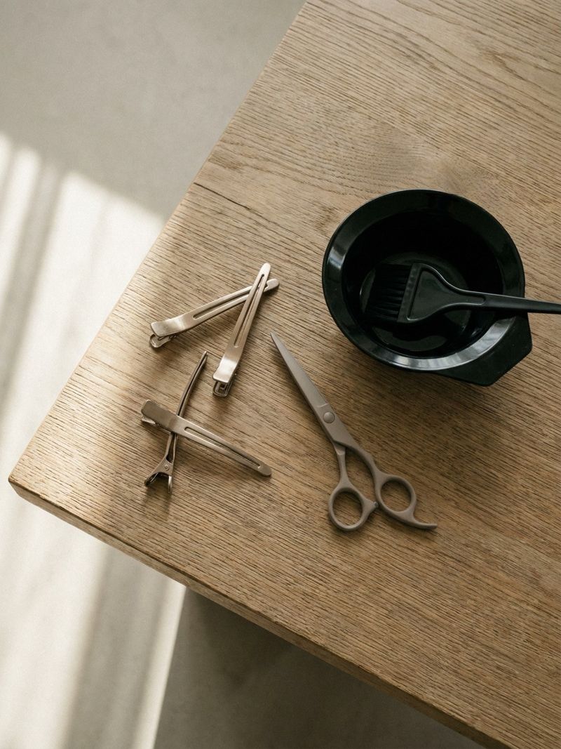 Korean styling tools flat lay Overhead flat lay of professional Korean styling tools on a raw oak surface, including sectioning clips, ceramic shears, and a color bowl | Sky Rye Design Overhead flat lay of professional Korean styling tools on a raw oak surface, including sectioning clips, ceramic shears, and a color bowl