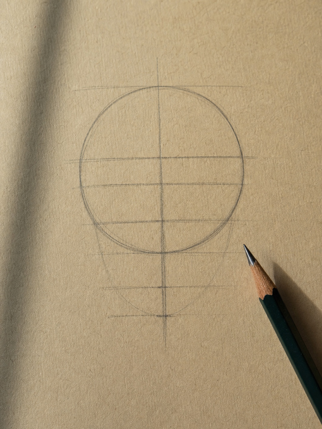 Loomis method sphere and cross construction diagram Graphite Loomis method sphere diagram with center cross and facial guideline marks on toned sketch paper. | Sky Rye Design Graphite Loomis method sphere diagram with center cross and facial guideline marks on toned sketch paper.