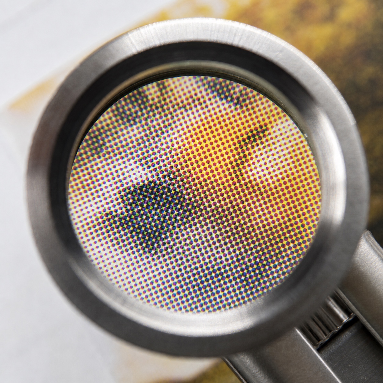 Loupe inspecting halftone dots Designer loupe magnifying halftone dots on a printed proof. | Sky Rye Design Designer loupe magnifying halftone dots on a printed proof.