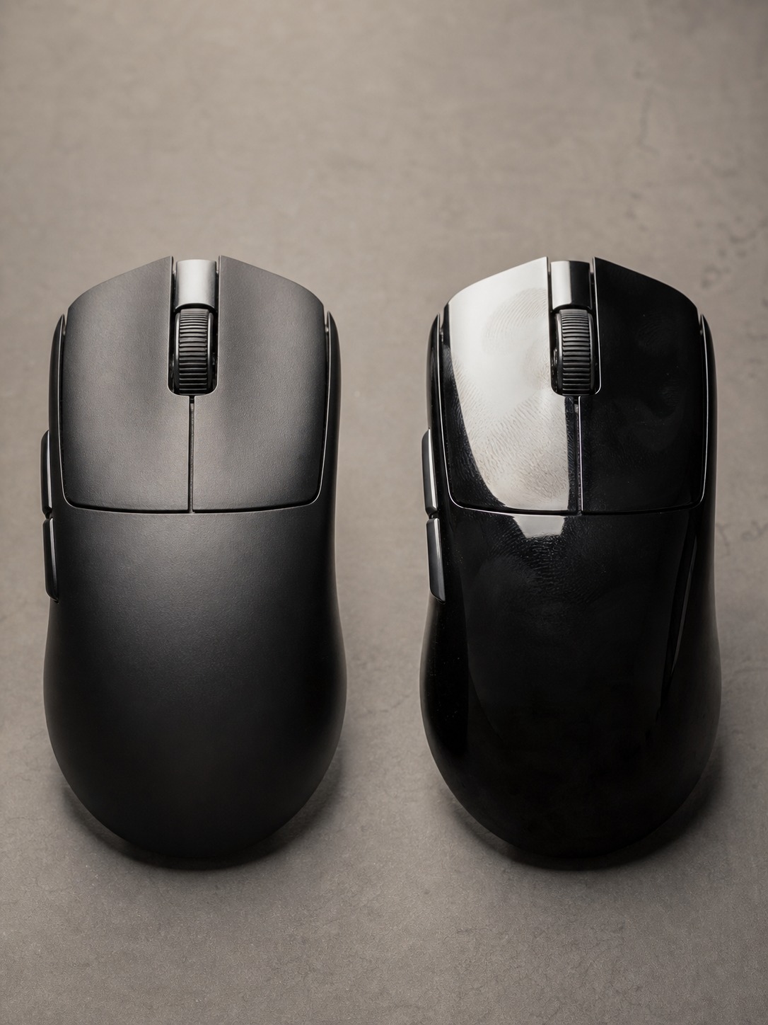 Side-by-side comparison of matte and glossy wireless gaming mouse shells under studio lighting