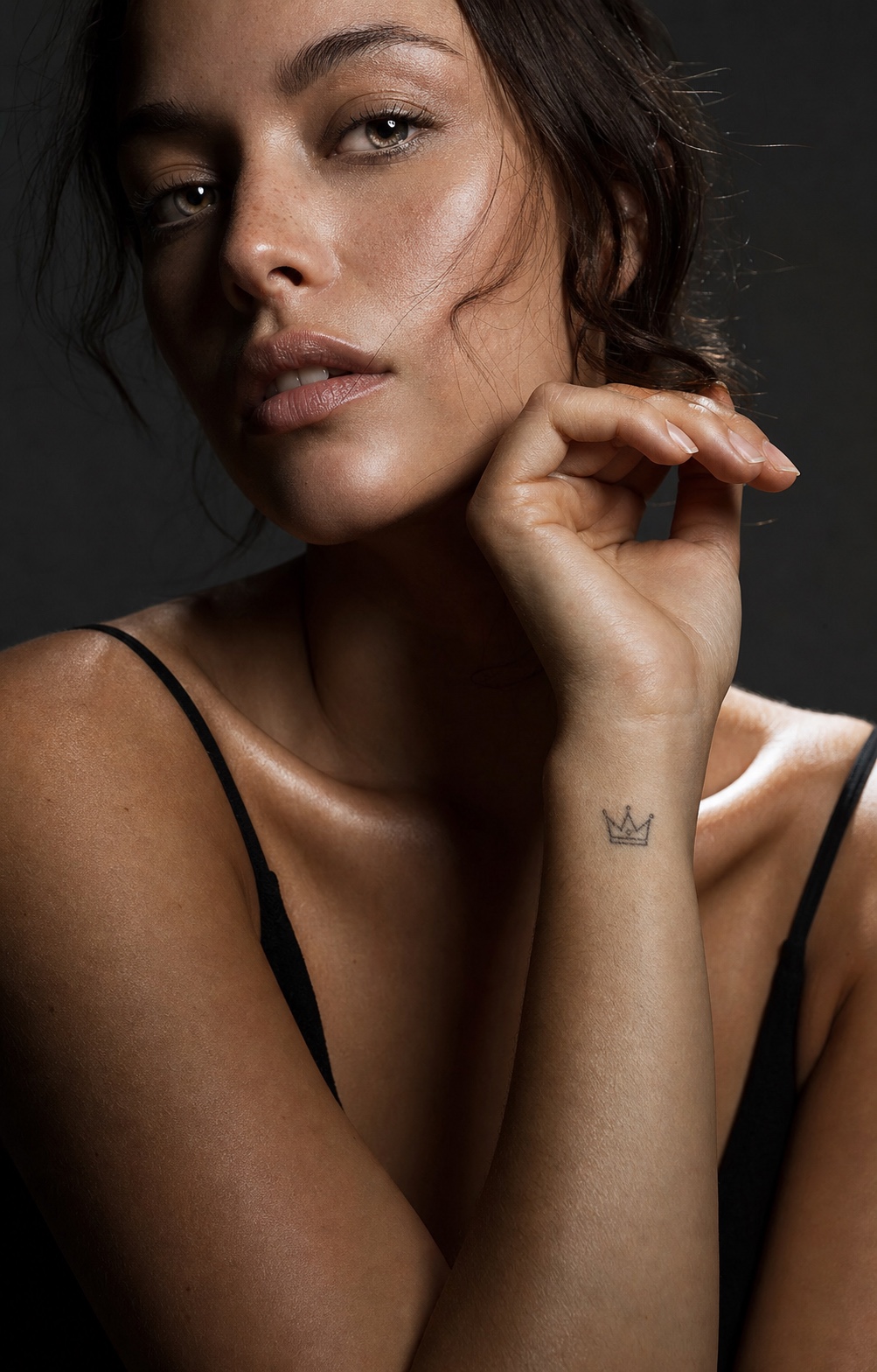 Minimalist crown wrist tattoo Minimalist fine-line crown tattoo on the inner wrist in a studio portrait. | Sky Rye Design Minimalist fine-line crown tattoo on the inner wrist in a studio portrait.