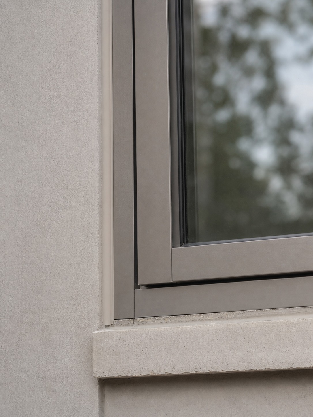 Window sash sitting slightly askew in its track, creating a subtle misalignment against the surrounding frame.