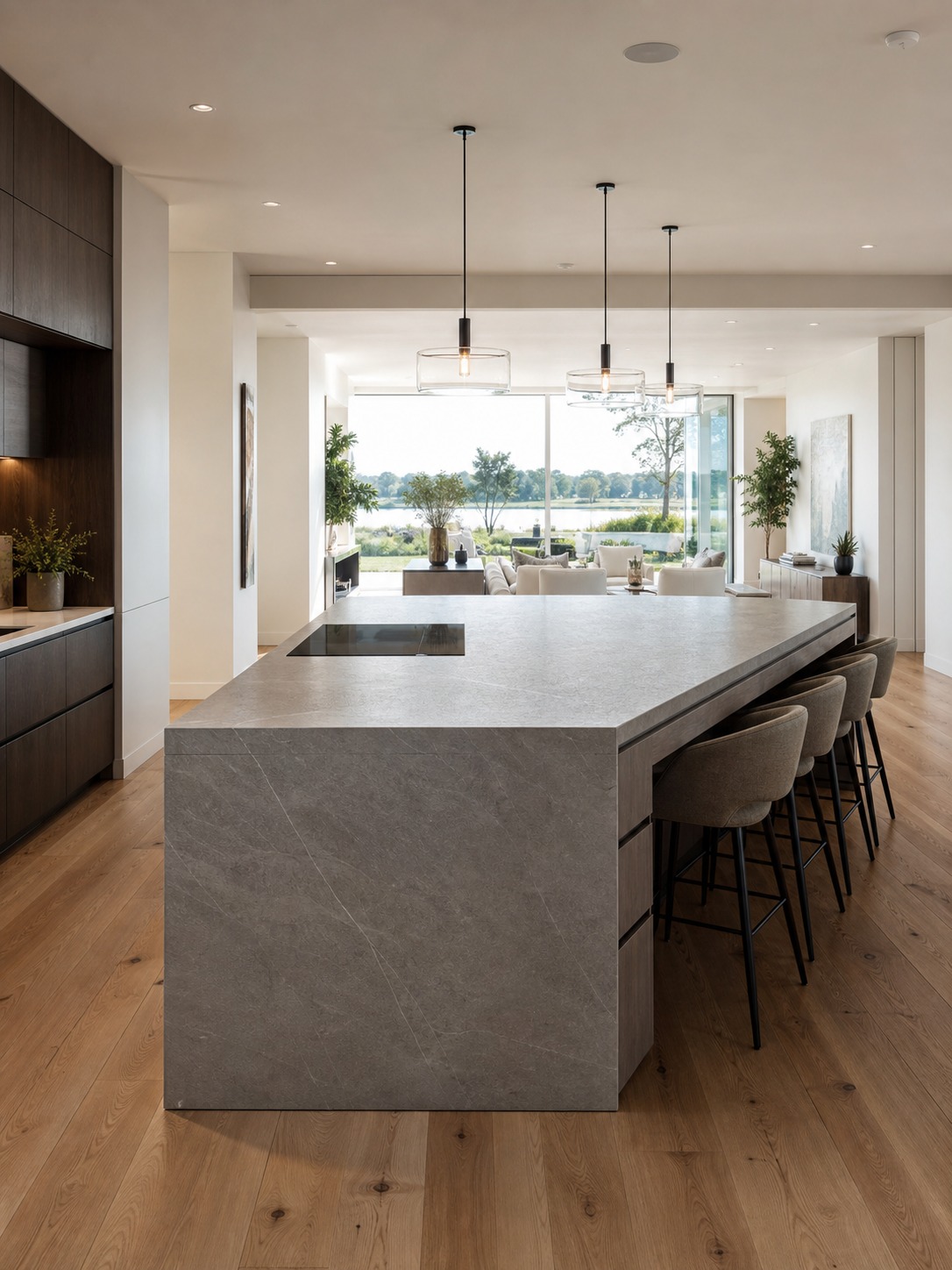 Modern kitchen island dividing prep and living zones Ultra-modern kitchen island with integrated seating separating the prep zone from an open living area. | Sky Rye Design Ultra-modern kitchen island with integrated seating separating the prep zone from an open living area.