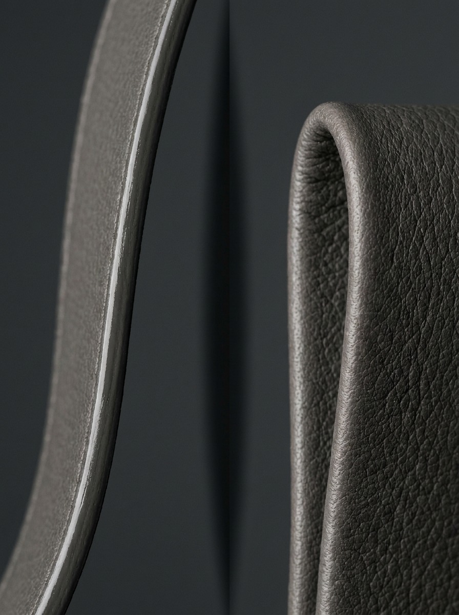 Painted versus folded leather edge comparison Side-by-side close-up comparing a painted leather edge with visible coating sheen against a folded leather edge showing continuous natural grain | Sky Rye Design Side-by-side close-up comparing a painted leather edge with visible coating sheen against a folded leather edge showing continuous natural grain