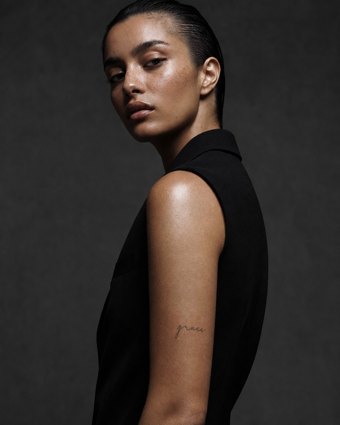 Grace upper arm word tattoo Grace word tattoo on the upper arm near the tricep with fine-line healed ink. | Sky Rye Design Grace word tattoo on the upper arm near the tricep with fine-line healed ink.