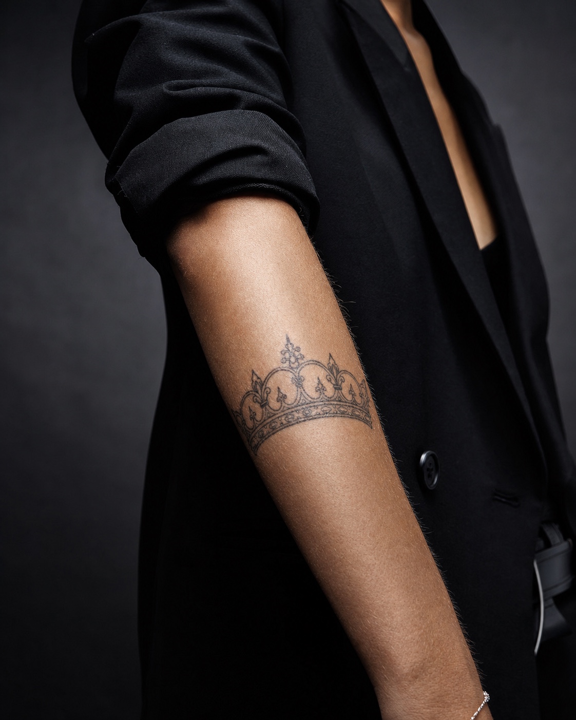 Queen crown forearm tattoo Fine-line queen crown tattoo on the outer forearm with healed black ink. | Sky Rye Design Fine-line queen crown tattoo on the outer forearm with healed black ink.