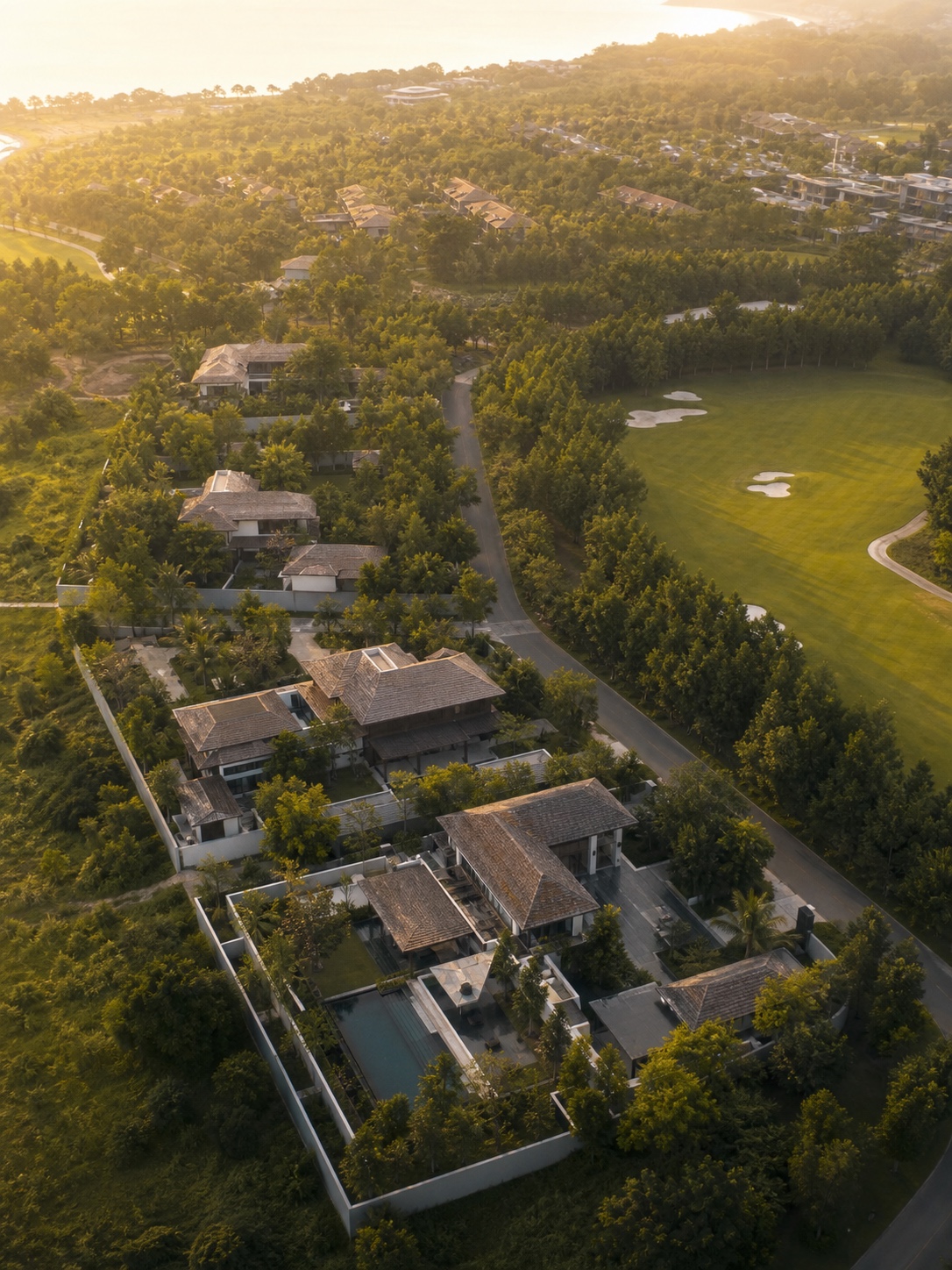 Low-density luxury residential master plan in Thailand Aerial view of a low-density luxury residential community in tropical Thailand with tree buffers and a golf fairway | Sky Rye Design Aerial view of a low-density luxury residential community in tropical Thailand with tree buffers and a golf fairway