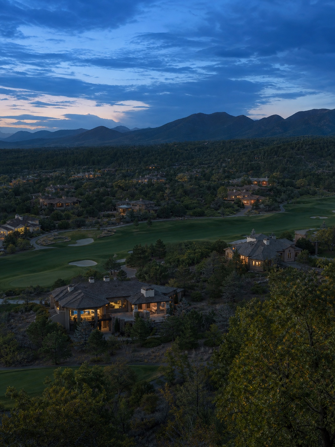 Private residential community at dusk Spaced-out luxury homes glowing across a golf course landscape at blue hour | Sky Rye Design Spaced-out luxury homes glowing across a golf course landscape at blue hour
