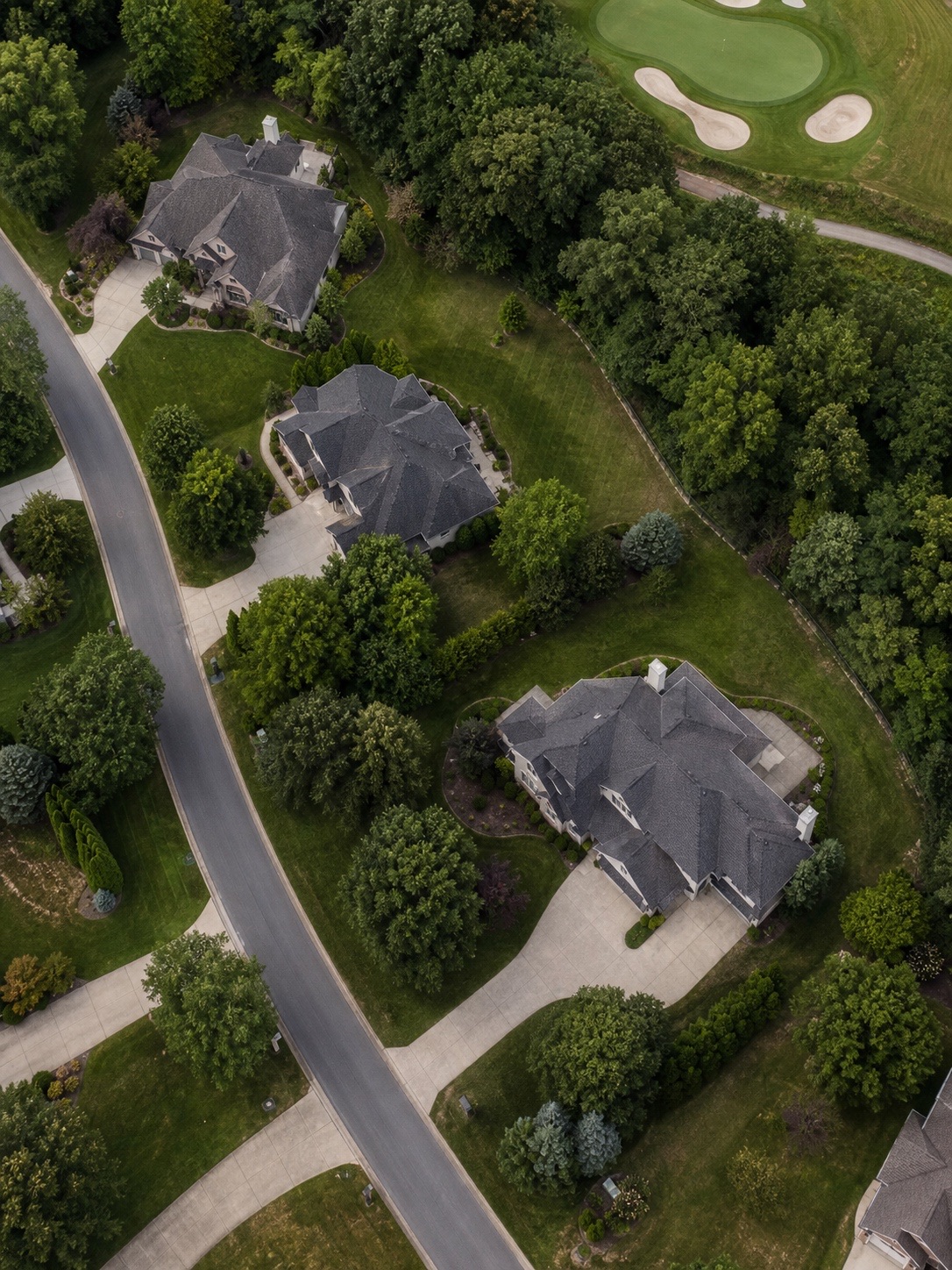 Low-density residential plots beside a golf course Overhead view of low-density residential plots with visible setbacks, landscaping, and a golf course edge | Sky Rye Design Overhead view of low-density residential plots with visible setbacks, landscaping, and a golf course edge