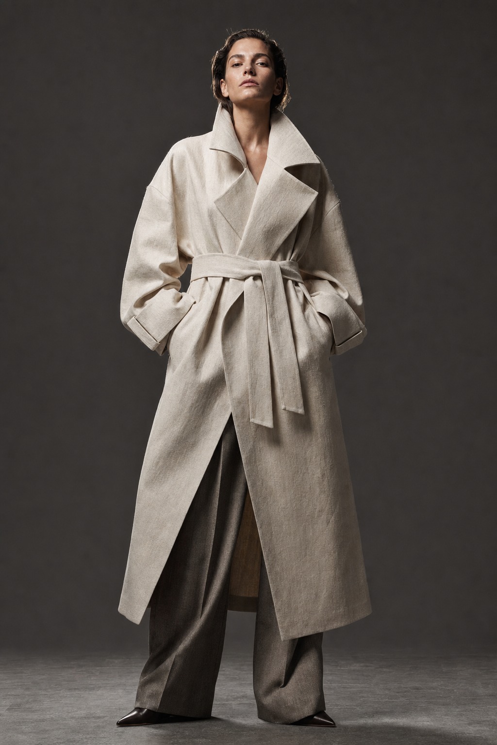 Organic linen trench coat editorial for ethical fashion brands High-fashion model wearing a sculptural cream organic linen trench coat and recycled wool trousers | Sky Rye Design High-fashion model wearing a sculptural cream organic linen trench coat and recycled wool trousers