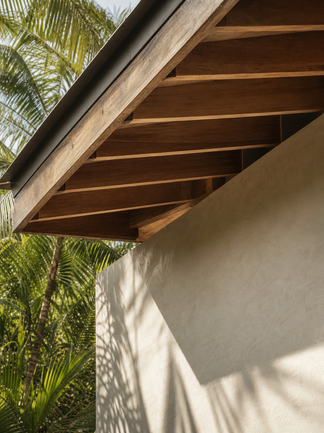 Deep roof overhang and timber eave in a tropical residence Deep roof overhang and timber eave casting patterned shade across a tropical residence wall | Sky Rye Design Deep roof overhang and timber eave casting patterned shade across a tropical residence wall