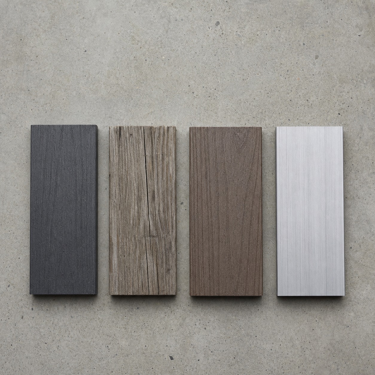 Flat lay of waterfront decking samples including HDPE, weathered timber, composite, and brushed aluminum.