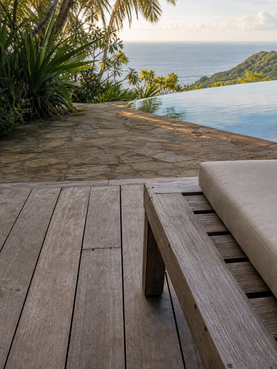 Weathered teak deck and natural stone terrace Weathered teak deck and natural stone poolside terrace surrounded by tropical planting | Sky Rye Design Weathered teak deck and natural stone poolside terrace surrounded by tropical planting