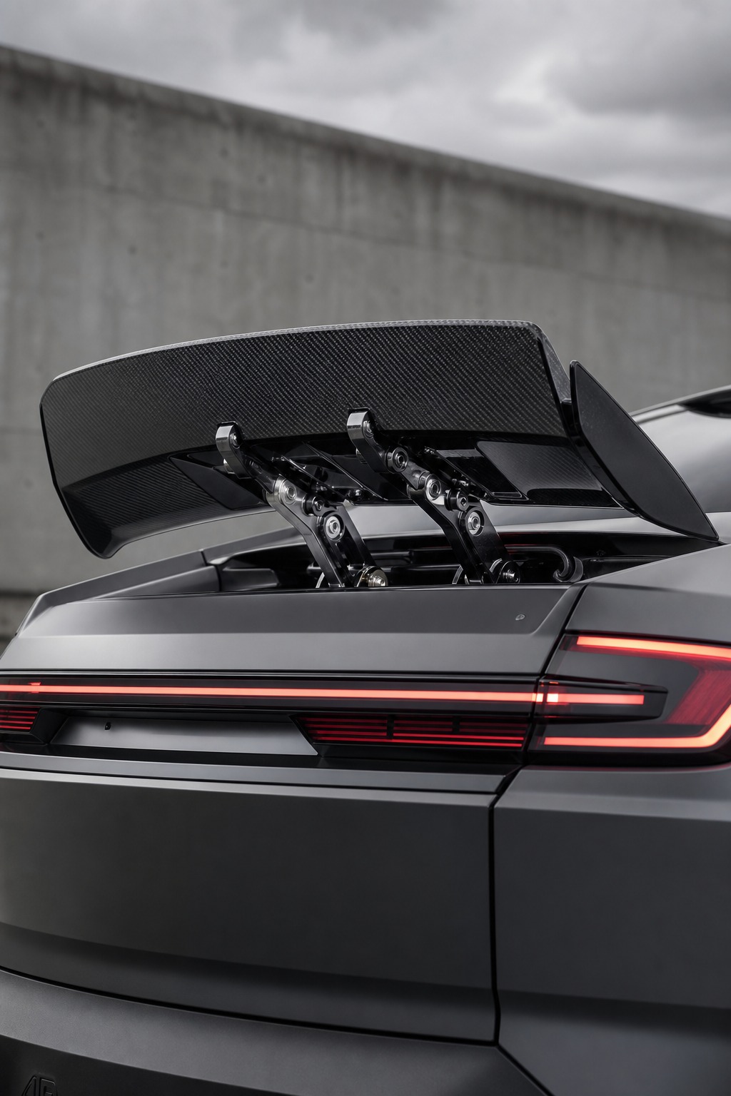 Active aerodynamic rear spoiler on EV An active aerodynamic rear spoiler deployed on a modern performance EV, with the mechanism visible. | Sky Rye Design An active aerodynamic rear spoiler deployed on a modern performance EV, with the mechanism visible.
