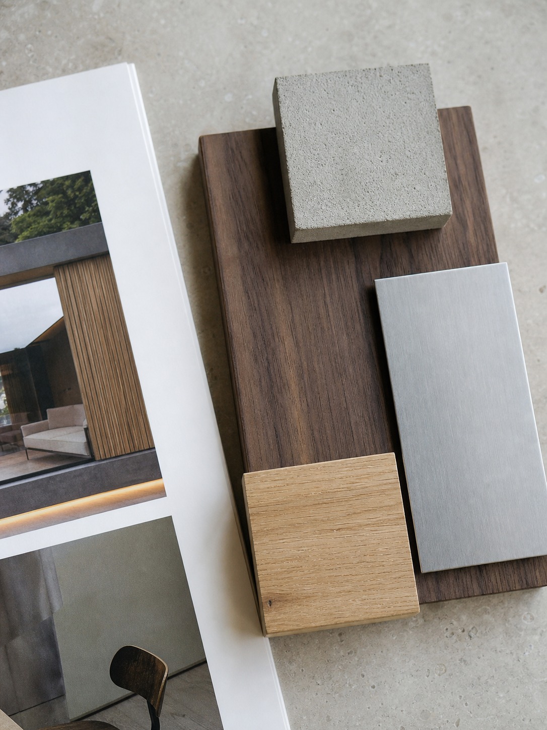 Architecture material board with wood concrete and metal samples beside a portfolio page