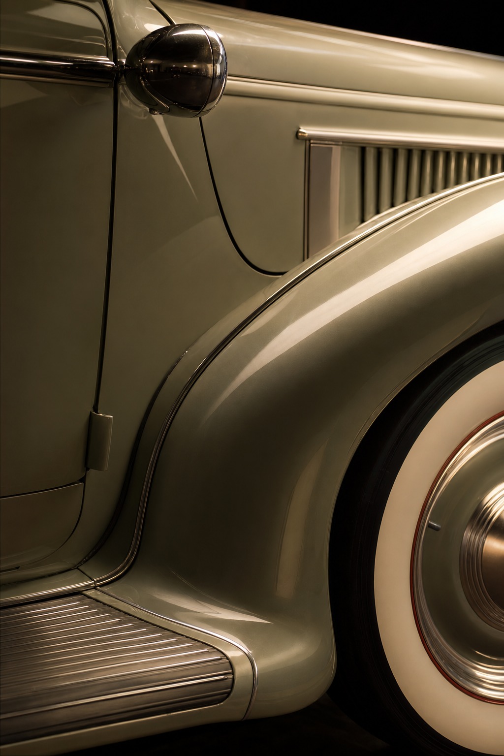 Art Deco car fender and running board detail A historic Art Deco-era car body detail showing an integrated fender and running board curve. | Sky Rye Design A historic Art Deco-era car body detail showing an integrated fender and running board curve.