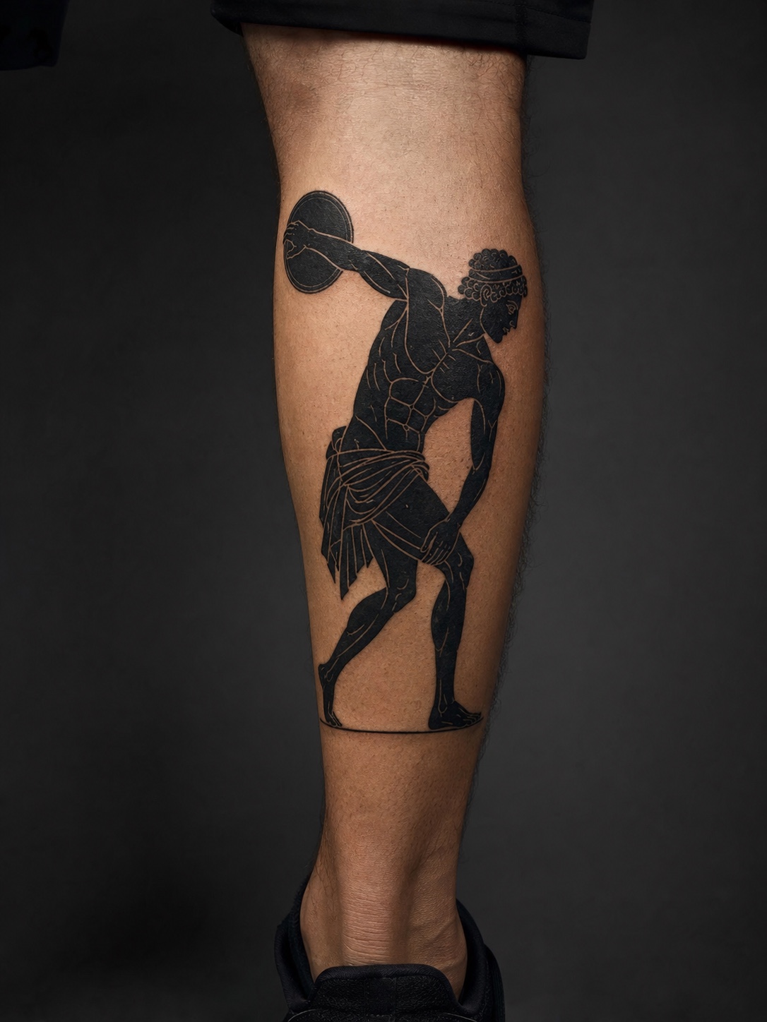 Black-figure pottery calf tattoo Calf tattoo of a Greek figure in black-figure pottery style with incised details. | Sky Rye Design Calf tattoo of a Greek figure in black-figure pottery style with incised details.